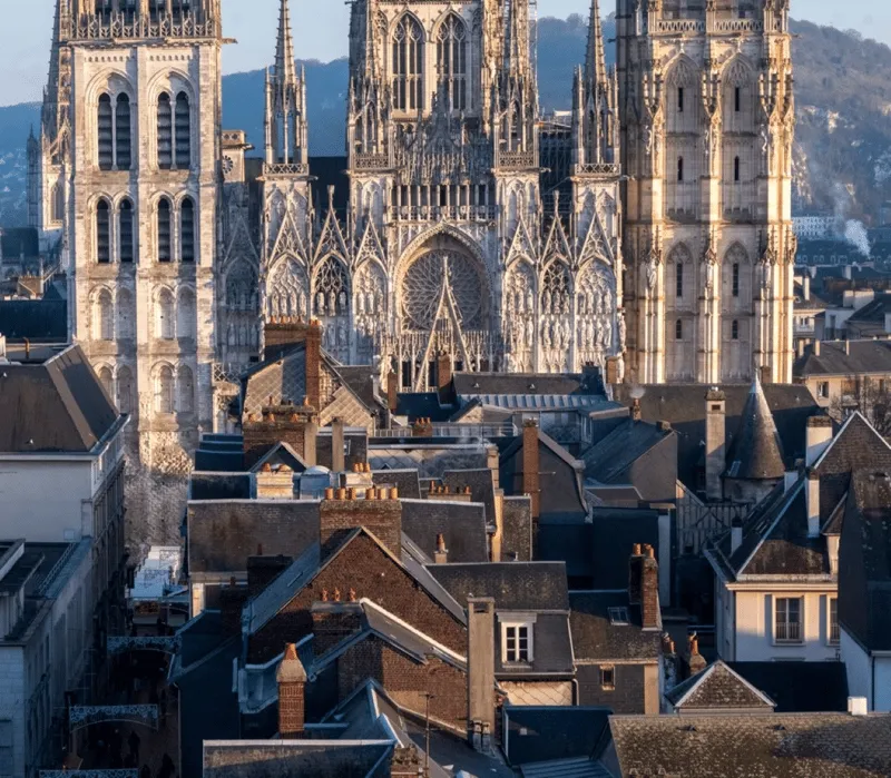 Official licensed guide addressing an English-speaking group outside the cathedral on a rouen cathedral tour in Rouen, France